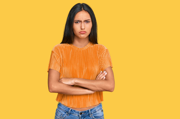 Young brunette arab woman wearing casual clothes skeptic and nervous, disapproving expression on face with crossed arms. negative person.  - Photo, Image