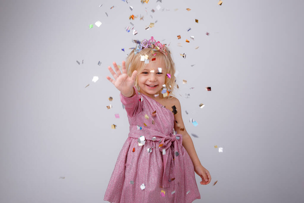 cute little girl posing in studio in pink dress and crown - Valokuva, kuva