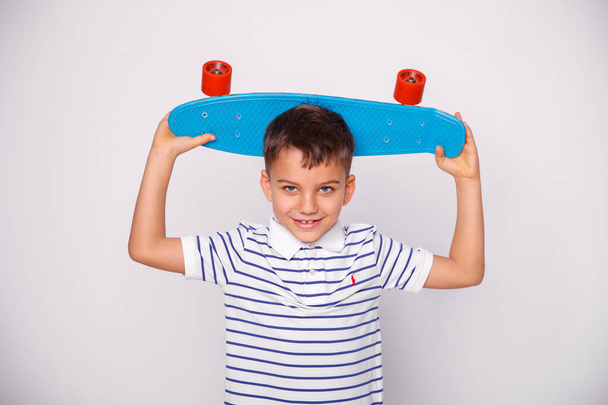 cute skater boy posing in studio  - Фото, изображение