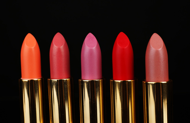 Beautiful lipsticks on black background - Photo, image