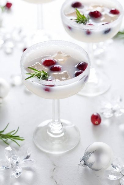 White Christmas margarita punch with cranberries and rosemary on marble background - Valokuva, kuva