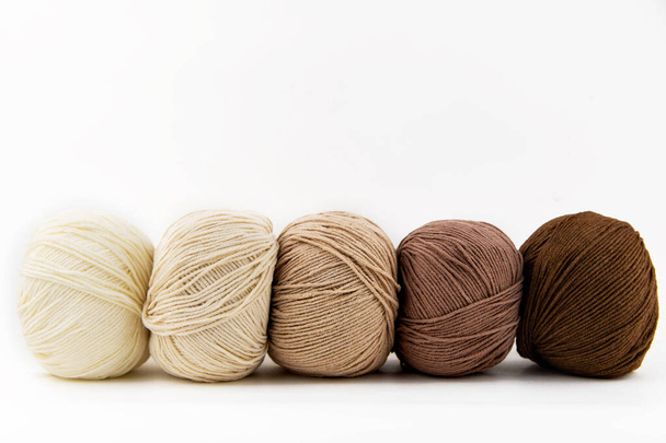 Balls of yarn for knitting brown flowers on a white background. - Foto, Bild