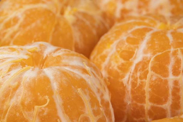 Lots of un peeled tangerines close-up. Super macro. - Photo, Image