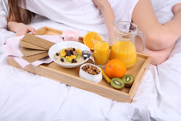 Woman in bed with light breakfast  - Фото, изображение