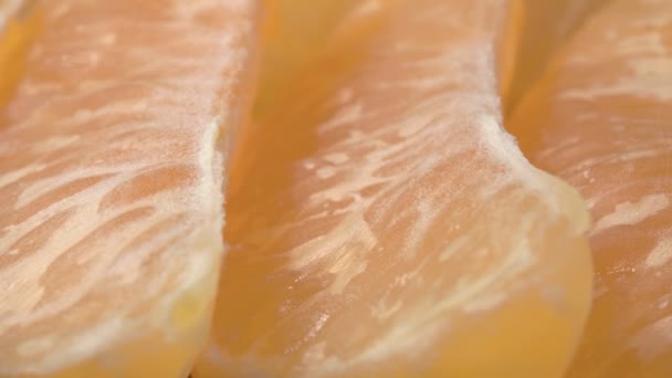 Mandarin slices close-up. Super macro video. Exotic fruit. - Footage, Video