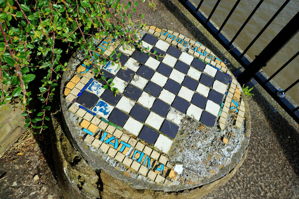 London, United Kingdom - June 23, 2018: Closeup taken from an angle of old outdoor chess table located next to River Thames - Photo, Image