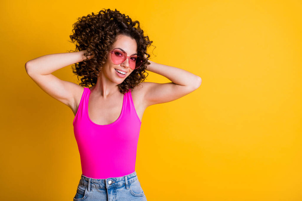 Close-up portrait of her she nice-looking attractive pretty lovable lovely cheerful cheery wavy-haired girl posing touching hairdress isolated on bright vivid shine vibrant yellow color background - Foto, Bild