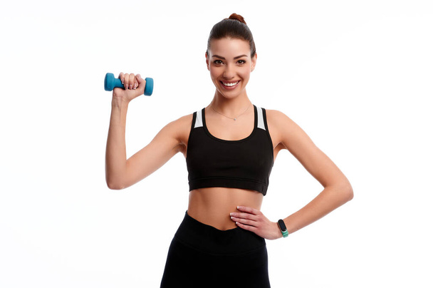 Young attractive caucasian slim woman doing physical exercise using dumbbell isolated on white background - Foto, immagini
