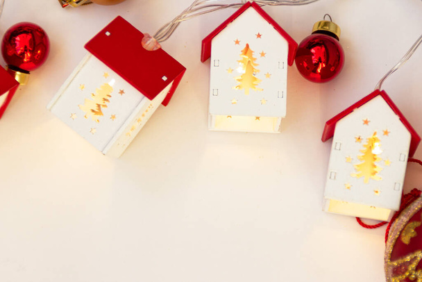 Christmas frame. Christmas balls, garlands, red and gold decorations on a white background. Flat lay, top view, copy space. - Fotó, kép
