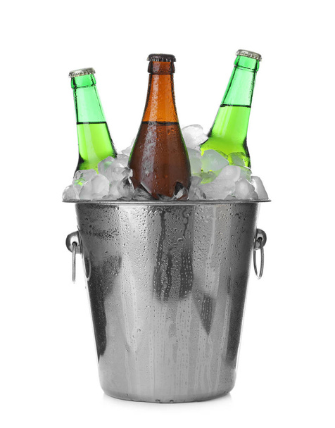 Metal bucket with bottles of beer and ice cubes isolated on white - Φωτογραφία, εικόνα