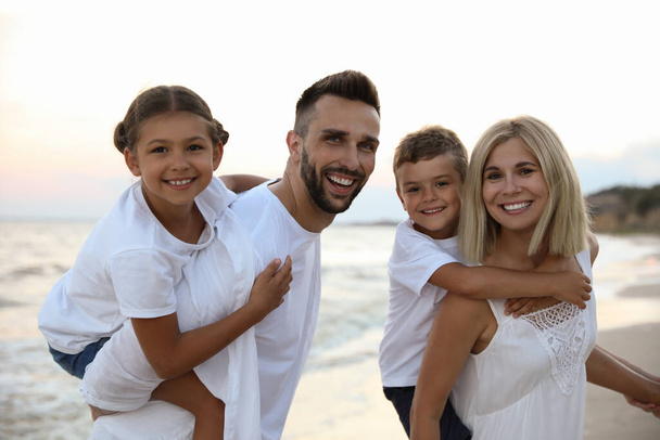 Happy family on beach near sea. Summer vacation - Φωτογραφία, εικόνα