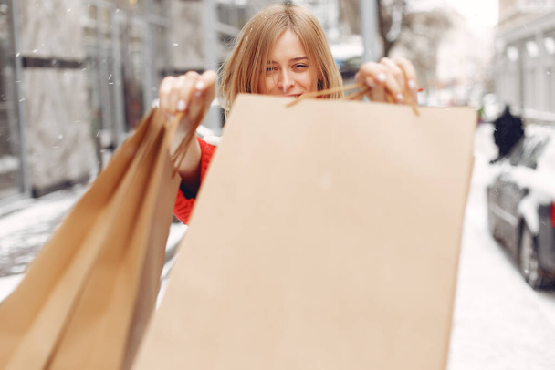 Woman carrying shopping bags at an outdoor shopping mall - Photo, image
