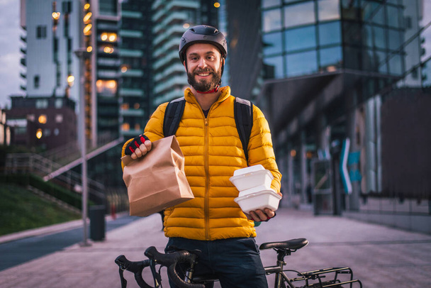 Food delivery service, rider delivering food to clints with bicycle - Concepts about transportation, food delivery and technology - Photo, Image