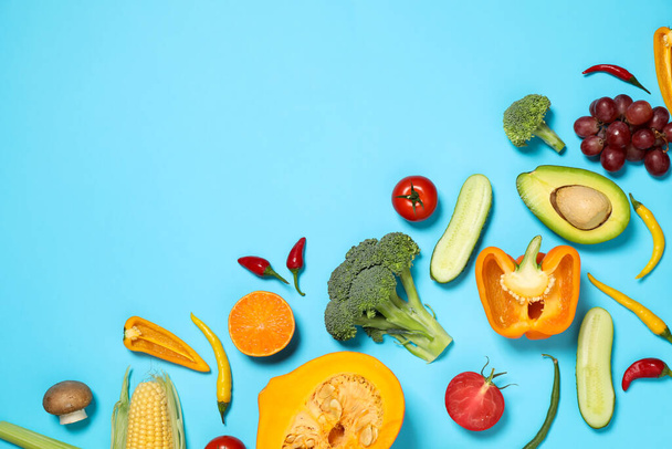 Flat lay composition with fresh organic fruits and vegetables on light blue background. Space for text - Foto, imagen