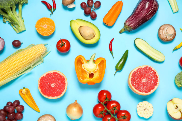 Flat lay composition with fresh organic fruits and vegetables on light blue background - Valokuva, kuva