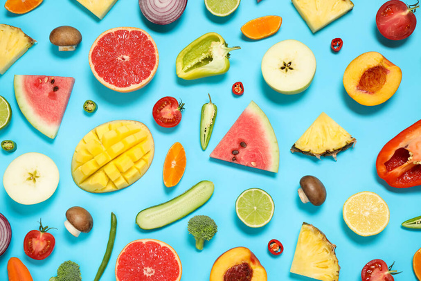 Flat lay composition with fresh organic fruits and vegetables on light blue background - Foto, Bild