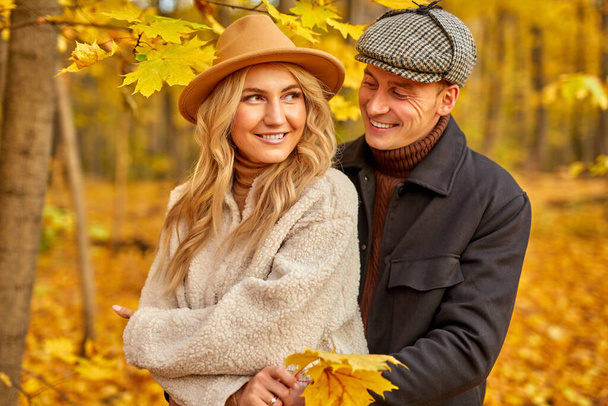 lovely couple posing in autumn forest - 写真・画像