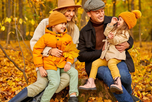 cheerful caucasian family have spare time in autumn park or forest - Fotoğraf, Görsel