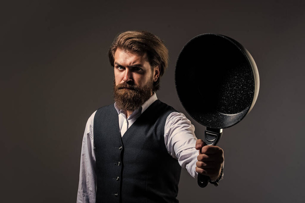 Elegant man hold frying pan cooking utensil, restaurant menu concept - Fotografie, Obrázek