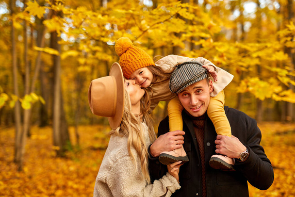 young caucaian family have fun in autumn park nature - 写真・画像
