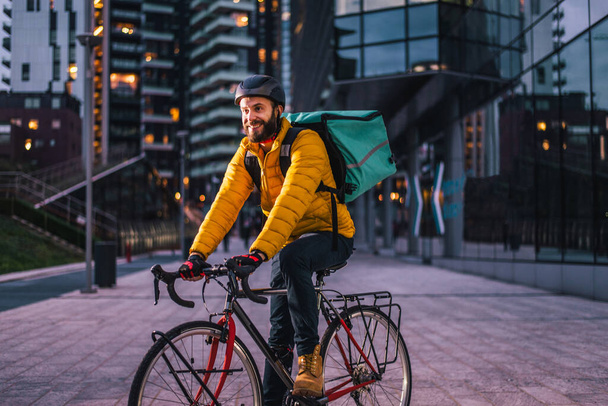 Food delivery service, rider delivering food to clints with bicycle - Concepts about transportation, food delivery and technology - Фото, зображення
