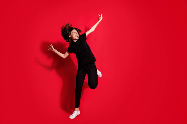 Photo portrait full body view of crazy girl dancing standing on one leg isolated on vivid red colored background - Fotoğraf, Görsel