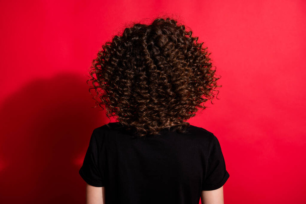Photo portrait back angle of curly girl isolated on vivid red colored background - Foto, immagini