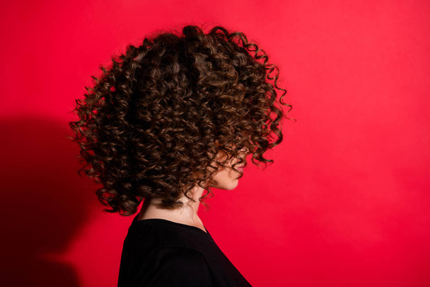 Photo portrait profile of woman with curly hair isolated on vivid red colored background - Fotó, kép