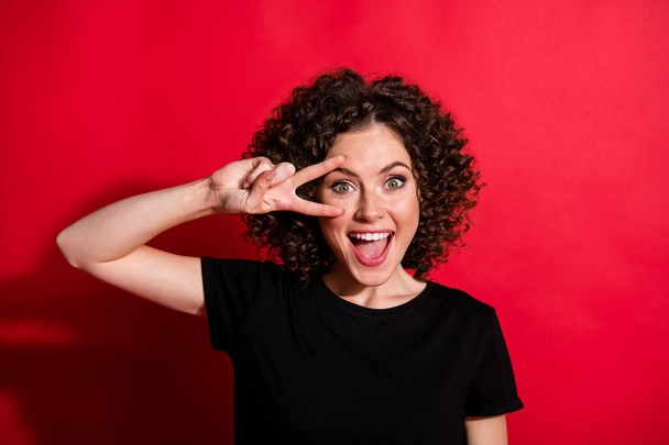 Photo of young person smile hand finger show v-sign happiness open mouth isolated on red color background - Fotografie, Obrázek
