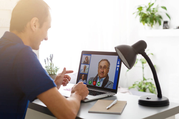 Man having video chat with doctor on laptop at home - Photo, Image
