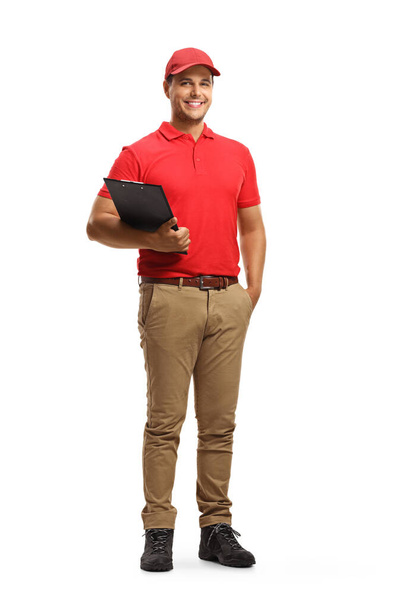 Full length portrait of a smiling man in a uniform holding a clipboard isolated on white background - Photo, image