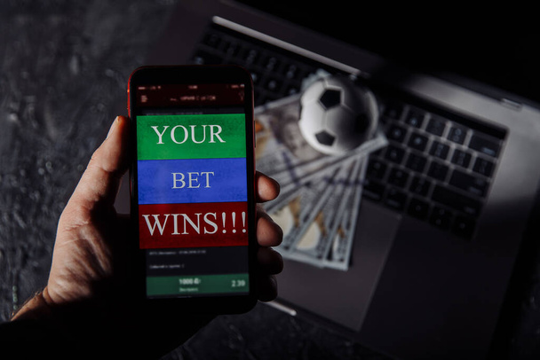 Man holding smartphone with winning result of his bet - Photo, Image