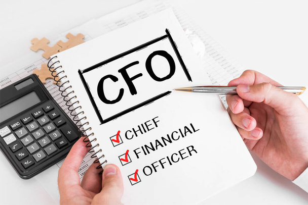 Businessman Writing CFO Concepts on his Note.. - Φωτογραφία, εικόνα