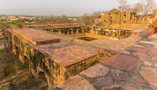 A view across a well at the abandoned temple at Fathepur Sikri, India at sunset - Photo, Image