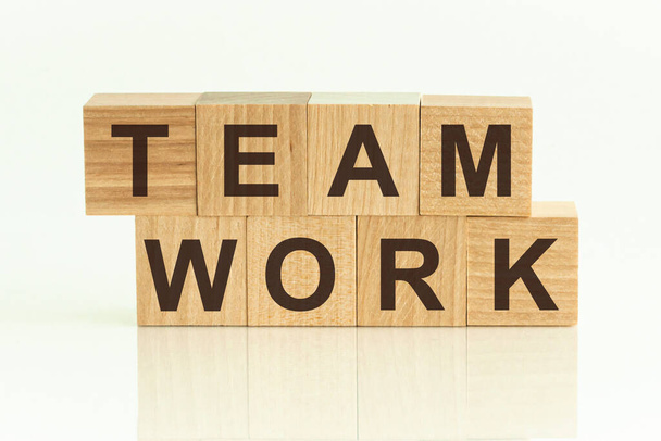 Team Work - text on wooden cubes on a white gradient background. - Photo, Image