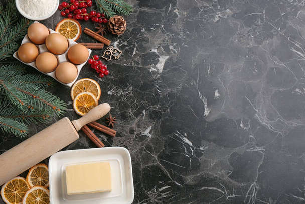 Flat lay composition with ingredients for homemade Christmas cookies on grey table, space for text - Fotoğraf, Görsel