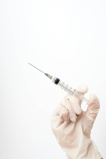 Medical - Syringe with hand and white background - Zdjęcie, obraz