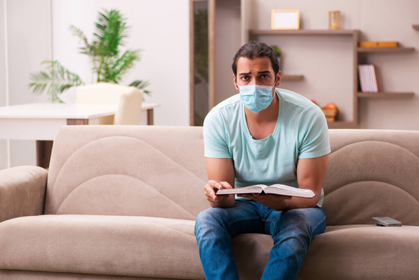 Young male student studying at home during pandemic - Φωτογραφία, εικόνα