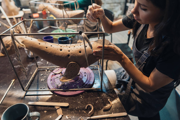 Portrait of young woman enjoying favorite job in workshop. - Photo, Image