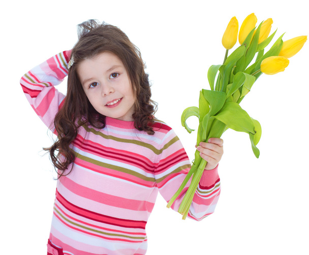 Charming little girl with yellow tulips. - Foto, Bild