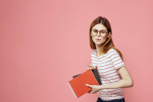 beautiful female student holding books education institute gesturing with hands pink background Copy Space - Photo, Image