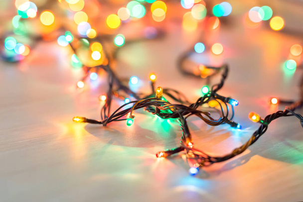 Christmas lights on dark blue background with copy space. Decorative garland - Foto, Imagem