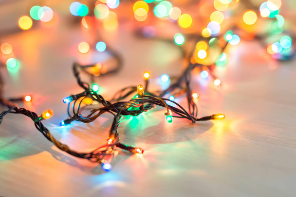 Christmas lights on dark blue background with copy space. Decorative garland - Zdjęcie, obraz