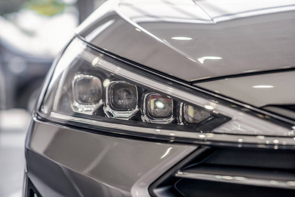 Close-up of new grey car front lights - Foto, immagini