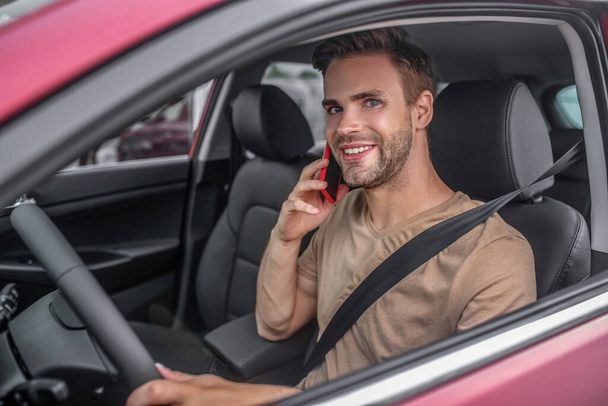 Smiling young male driving, talking on the phone - Foto, Imagem