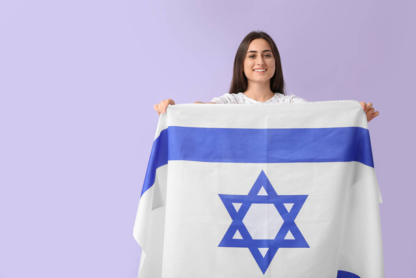 Young woman with the flag of Israel on color background - Valokuva, kuva