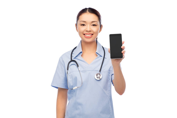 happy asian female doctor or nurse with smartphone - Photo, image