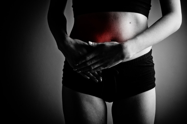 Woman suffering from abdominal pain - Foto, afbeelding