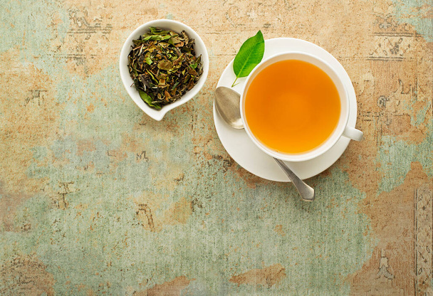 Tea cup with green tea leaf . Healthy concept - 写真・画像