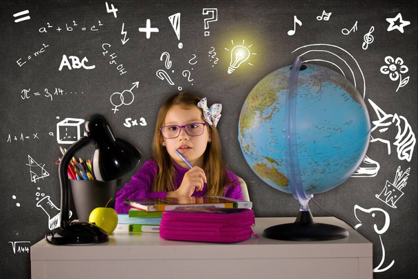 Back to school. Girl with glasses sitting over a pile of textbooks. - Foto, imagen
